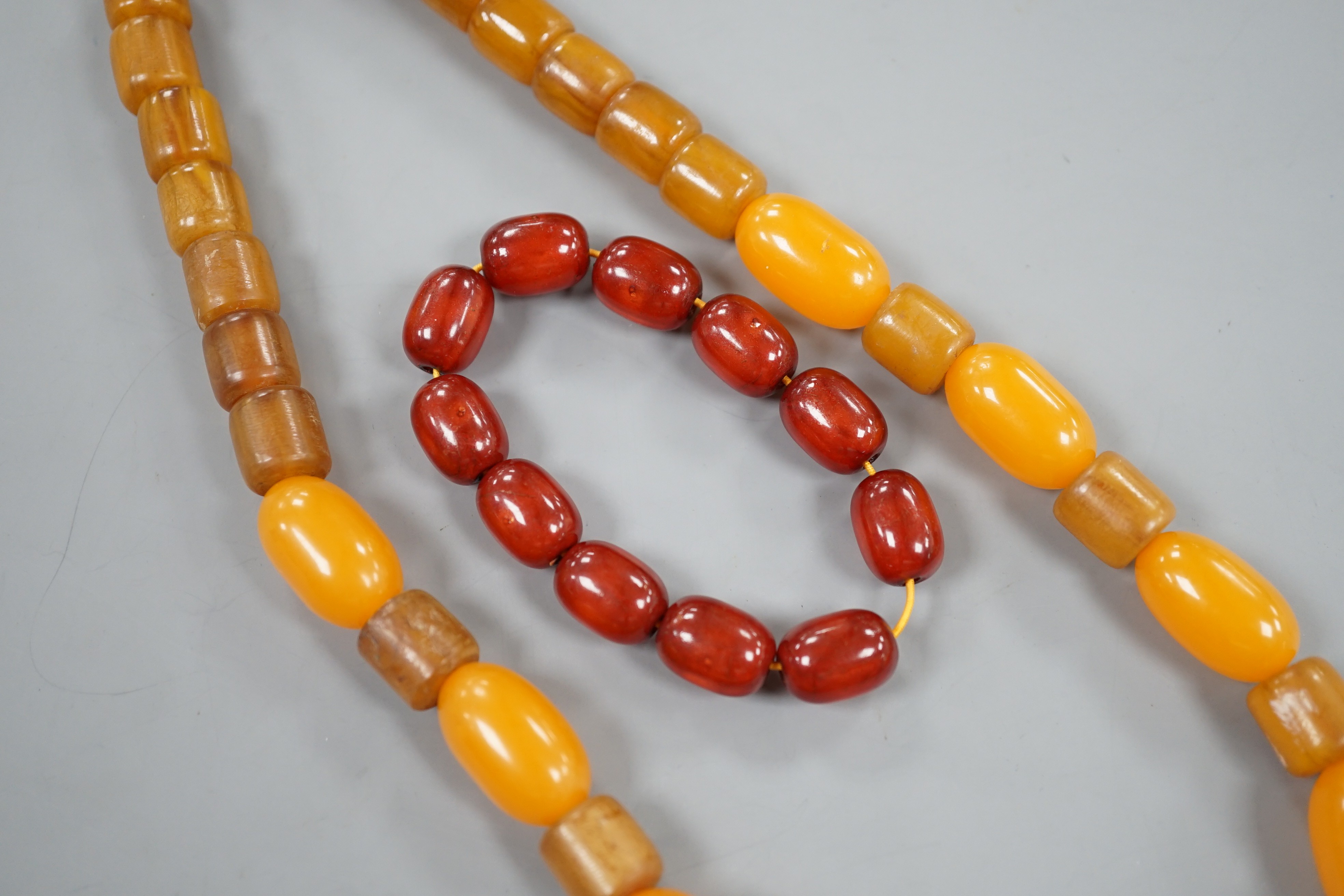 An amberoid expanding bracelet, and an amberoid necklace, 46cm.